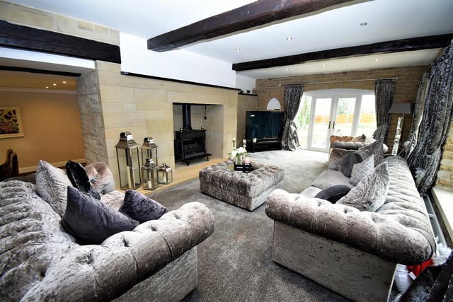 The huge fireplace is a focal point of this room, that has French doors out to the garden.