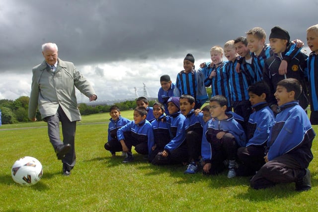 Sir Tom Finney shows off his skills to local schoolchildren on Moor Park
