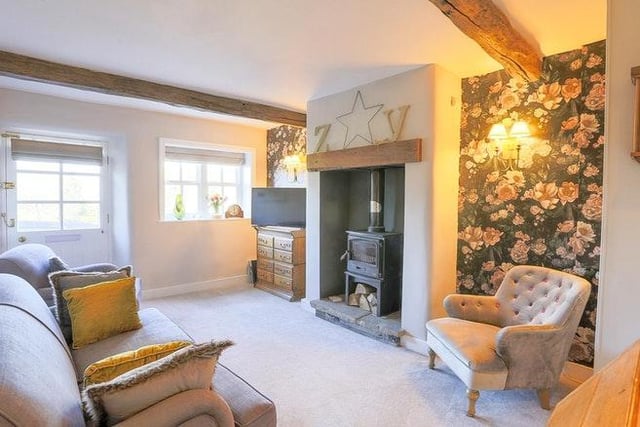 This room has an exposed beam and solid timber flooring, attractive feature Victorian style fireplace with coal effect gas fire and bespoke fitted glazed cabinets and bookshelves from the dining room you enter the Lounge with open fireplace and fitted wood burner stove and exposed beams.