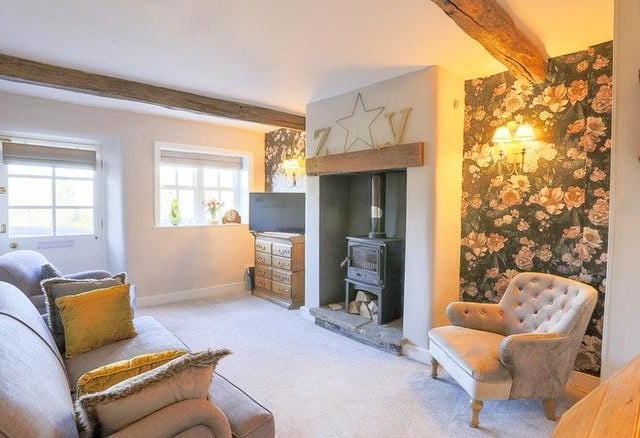 This room has an exposed beam and solid timber flooring, attractive feature Victorian style fireplace with coal effect gas fire and bespoke fitted glazed cabinets and bookshelves from the dining room you enter the Lounge with open fireplace and fitted wood burner stove and exposed beams.