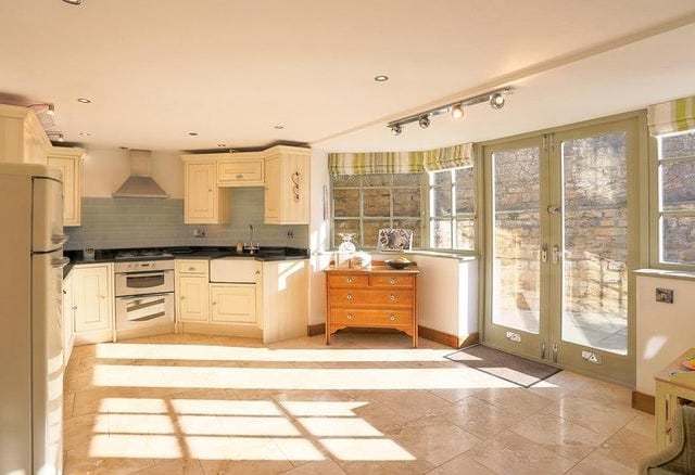 The large Kitchen is well fitted with a range of units including a deep glazed sink, marble work surfaces, built in oven, and hob with stainless steel canopy, integrated dishwasher & washing machine.