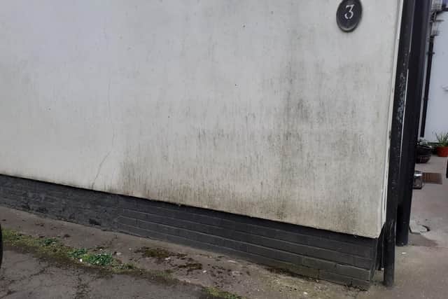 The wall of a property near a pothole on The Causeway in Burgh le Marsh.