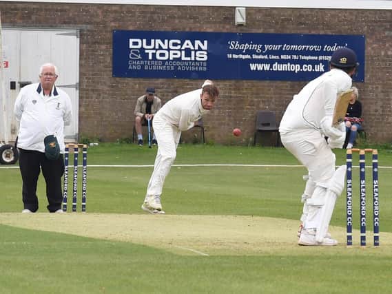 Woodhall Spa's Joe Irving sends down a delivery at Sleaford last year. Photo: David Dawson