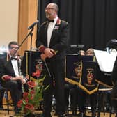 A previous year's Royal British Legion poppy prom with Sleaford Concert Band Director of Music Richard Joyce . EMN-200307-122652001