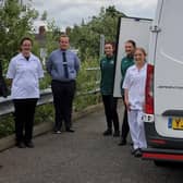 Coun Darren Hobson and wife Sarah-Jayne (left) with the Morrisons team.