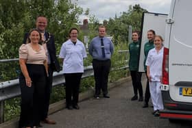 Coun Darren Hobson and wife Sarah-Jayne (left) with the Morrisons team.