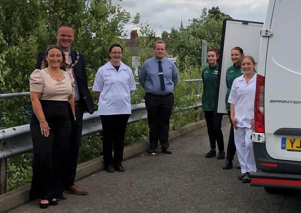 Coun Darren Hobson and wife Sarah-Jayne (left) with the Morrisons team.