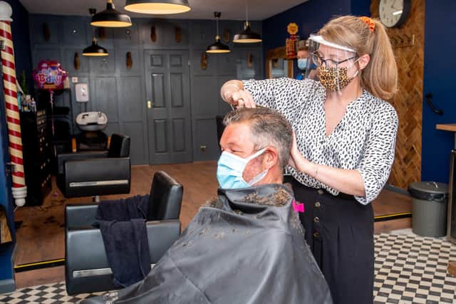 Sarah Pocklington (Clippers Mens's Hair Salon), giving Simon Shaw his first hair cut since March.