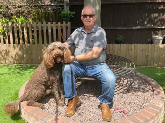 Robert Field at home with his dog, Byron.