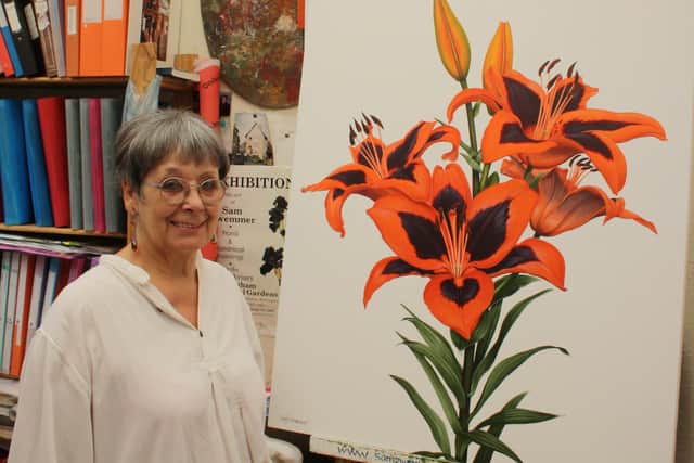 Botanical artist Sam Zwemmer with her painting of the flower chosen by pop star Lily Allen to bear her name.