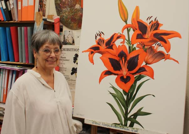 Botanical artist Sam Zwemmer with her painting of the flower chosen by pop star Lily Allen to bear her name.