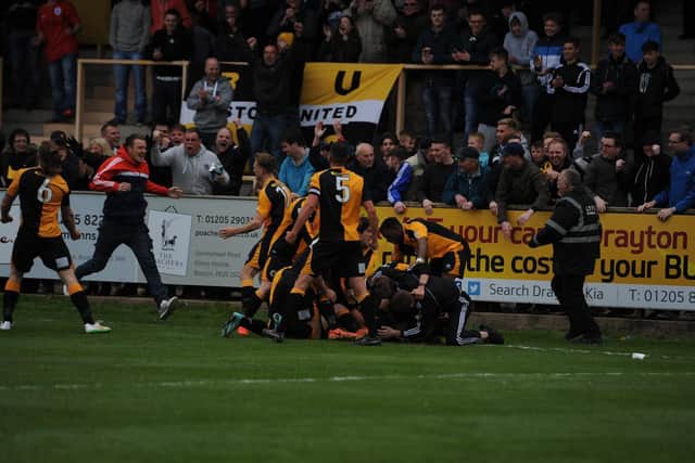 Garner and a supporter join in as players mob Kaine Felix after he netted against Chorley.