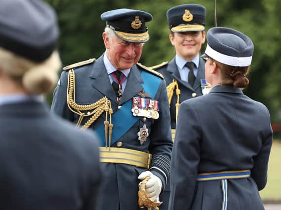Congratulating a graduate on parade at RAF College Cranwell - Prince Charles as reviewing officer.