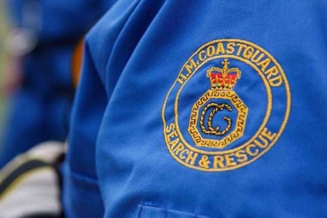 Dial 999 and ask for the coastguard in a coastal emergency.