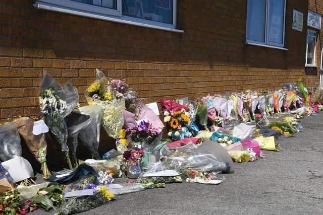 Floral tributes to Joy Everett left outside the theatre school.
