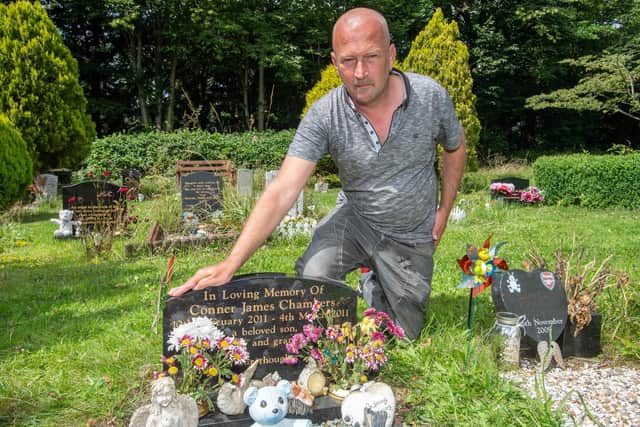 Darren Chambers at his son's grave.