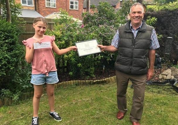 Garden expert John Stirland presents a certificate to Rebecca Shopland, winner of the Best Garden Created by Kids category in the Ropsley online garden competition EMN-200724-174649001