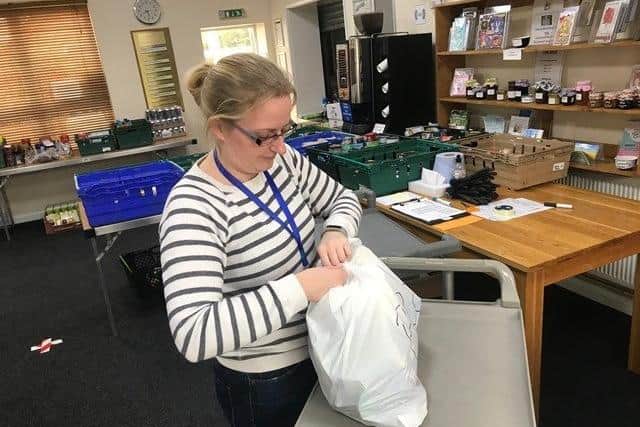 A volunteer preparing food packs at Sleaford New Life Community Larder EMN-200724-174719001