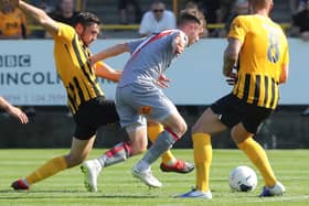 Tom Platt slides in against Altrincham during United's 5-0 victory in August. Photo: Eric Brown.