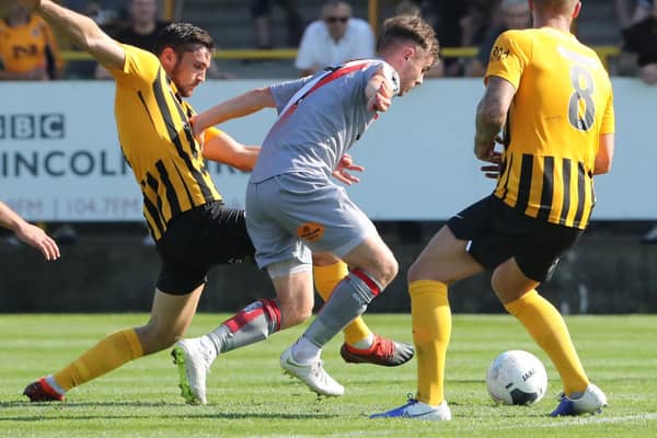 Tom Platt slides in against Altrincham during United's 5-0 victory in August. Photo: Eric Brown.