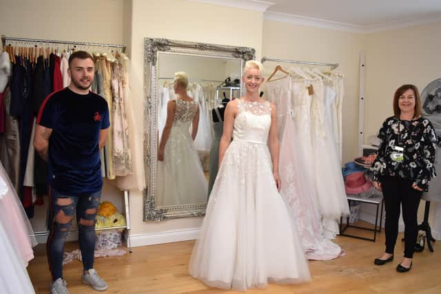 Ashley Hare (left) is pictured at The Wedding Loft with one of the donated dresses modelled by Gemma Chelton (centre) and Lindsey’s Shop Supervisor Beverley Blackley (right).