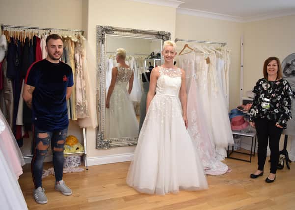 Ashley Hare (left) is pictured at The Wedding Loft with one of the donated dresses modelled by Gemma Chelton (centre) and Lindsey’s Shop Supervisor Beverley Blackley (right).