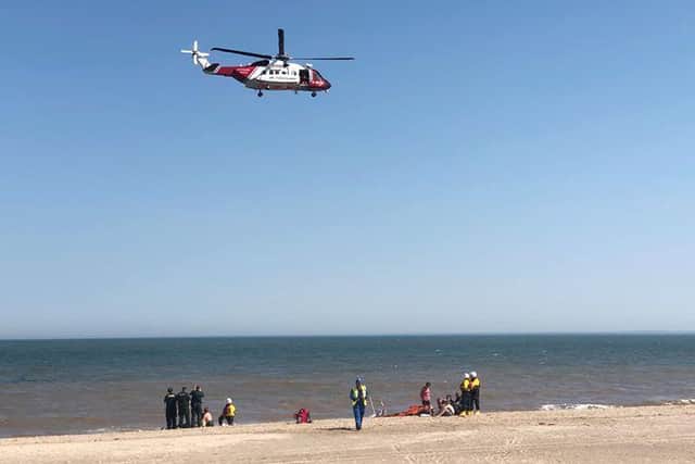 The air ambulance arriving at Skegness beach to take two casualties to hospital.