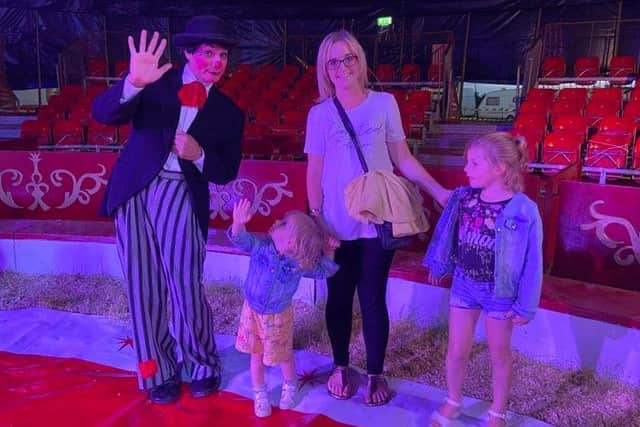 Sheridan Young of Winthorpe with Sophie, aged two, and Katelyn, six, meet the clown.