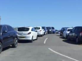 Accident waiting to happen - cars parked on both sides of the road at Anderby Creek.