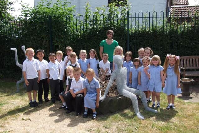 Sculptor James sutton, wwith Hogsthorpe Primary School children and their sculptures.