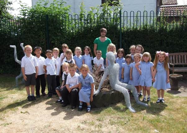 Sculptor James sutton, wwith Hogsthorpe Primary School children and their sculptures.