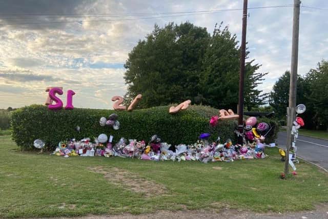 Flowers remain a reminder of the spot on the A158 where a woman pedestrian in her 20s died last month.