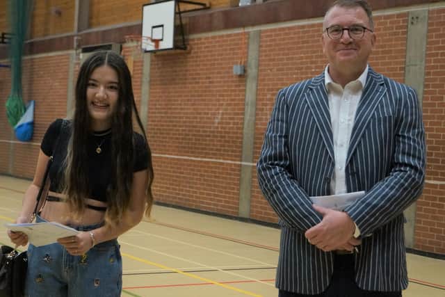 Head teacher Simon Porter with Jenny Radley, whose 2 A-grades and one A* will see her study at the University of York  EMN-200813-110552001