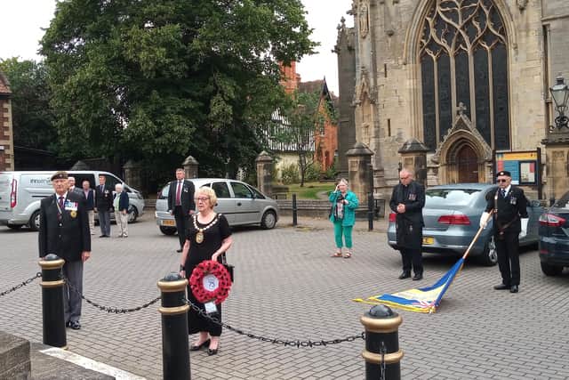 The two minute silence is held for VJ Day in Sleaford Market Place on Saturday. EMN-200817-154654001