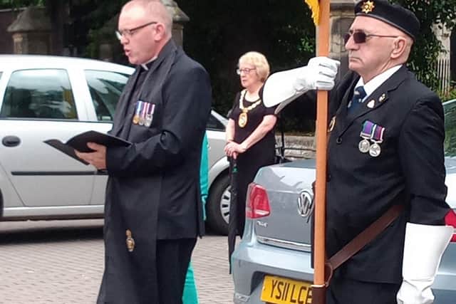 Rev Al Jenkins says prayers alongside British Legion standard bearer Brian Harvey. EMN-200817-154728001