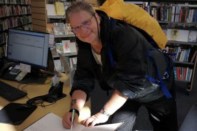 Malcolm  completing the The Viking Way by signing the book at Oakham library.