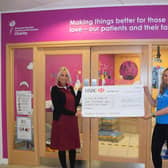 NHS nurse receiving the Soccersixes cheque for £2,025.