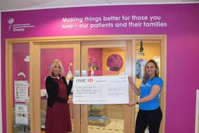 NHS nurse receiving the Soccersixes cheque for £2,025.