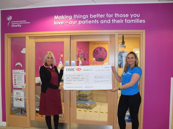 NHS nurse receiving the Soccersixes cheque for £2,025.