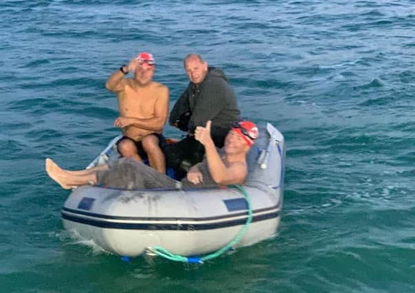 He's done it! Capt Harry Grantham heads back to his support boat after swimming the English Channel. EMN-201109-092744001