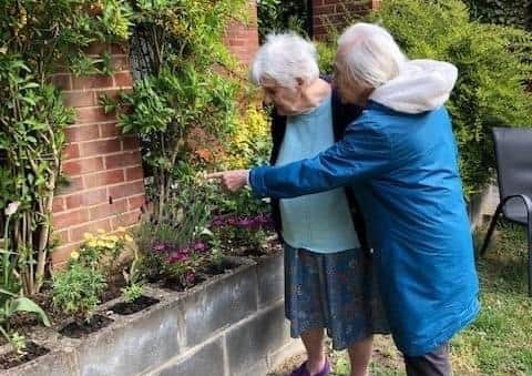 Ashdene residents enjoying the garden. EMN-201109-171821001