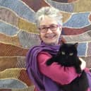 Author Ruth Taylor and her own cat Blackie.