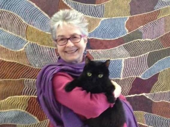 Author Ruth Taylor and her own cat Blackie.