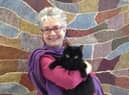 Author Ruth Taylor and her own cat Blackie.