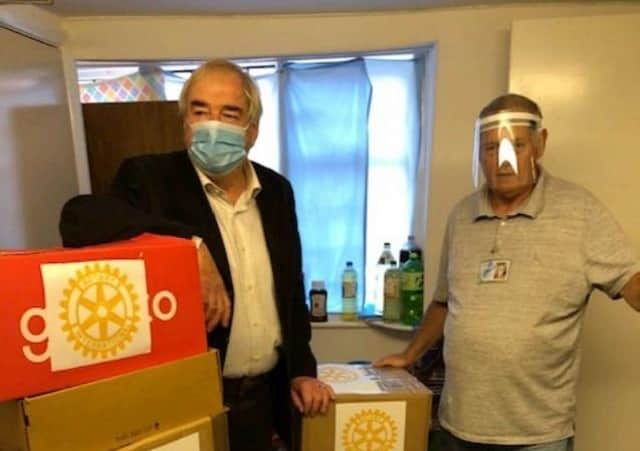 Rotary's Geoff Day (left) and Bob Taylor from the food bank.