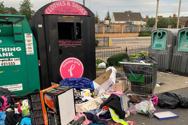 Rubbish dumped by a recycling bin