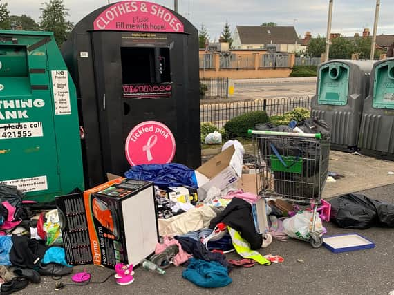 Rubbish dumped by a recycling bin