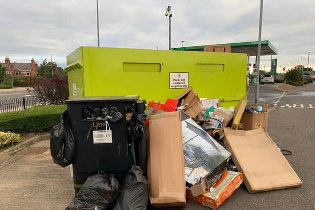Rubbish dumped by a recycling bin