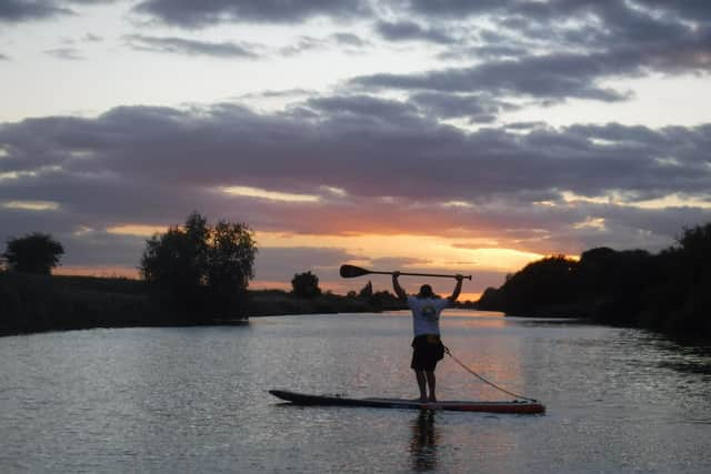 Carolyn enjoys the peace of paddle boarding.