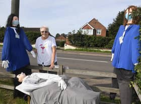 North Kyme scarecrow festival. Valarie Thomas looking at a scarecrow, made by her neighbour Sheila Palmer. EMN-200914-094101001